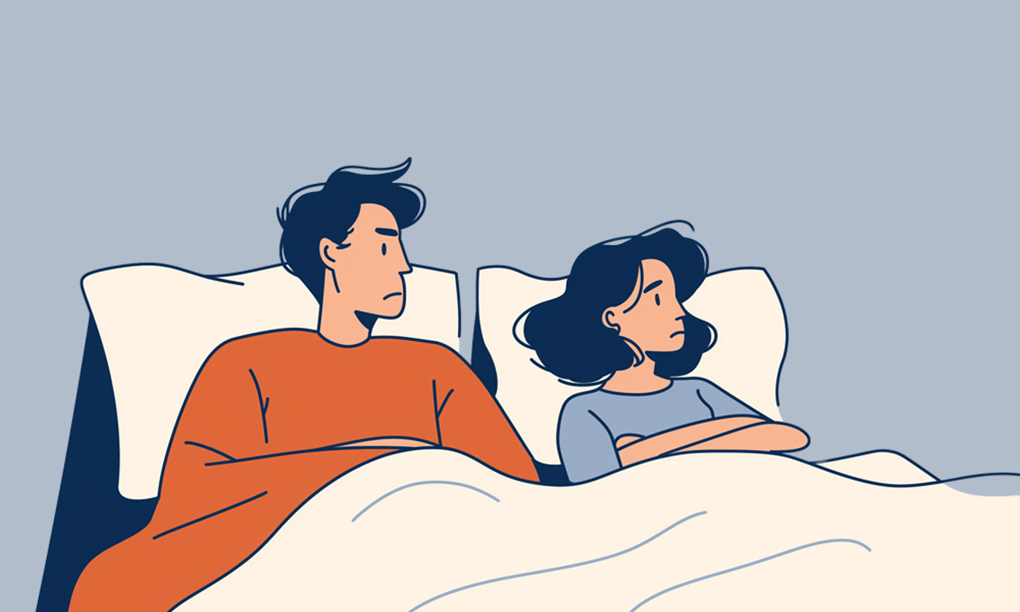 A couple in bed - he looks at her unhappily